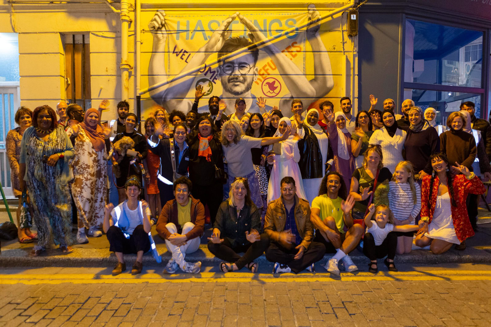 The Refugee Buddy Project celebrating their mural on Robertson Street, Hastings.